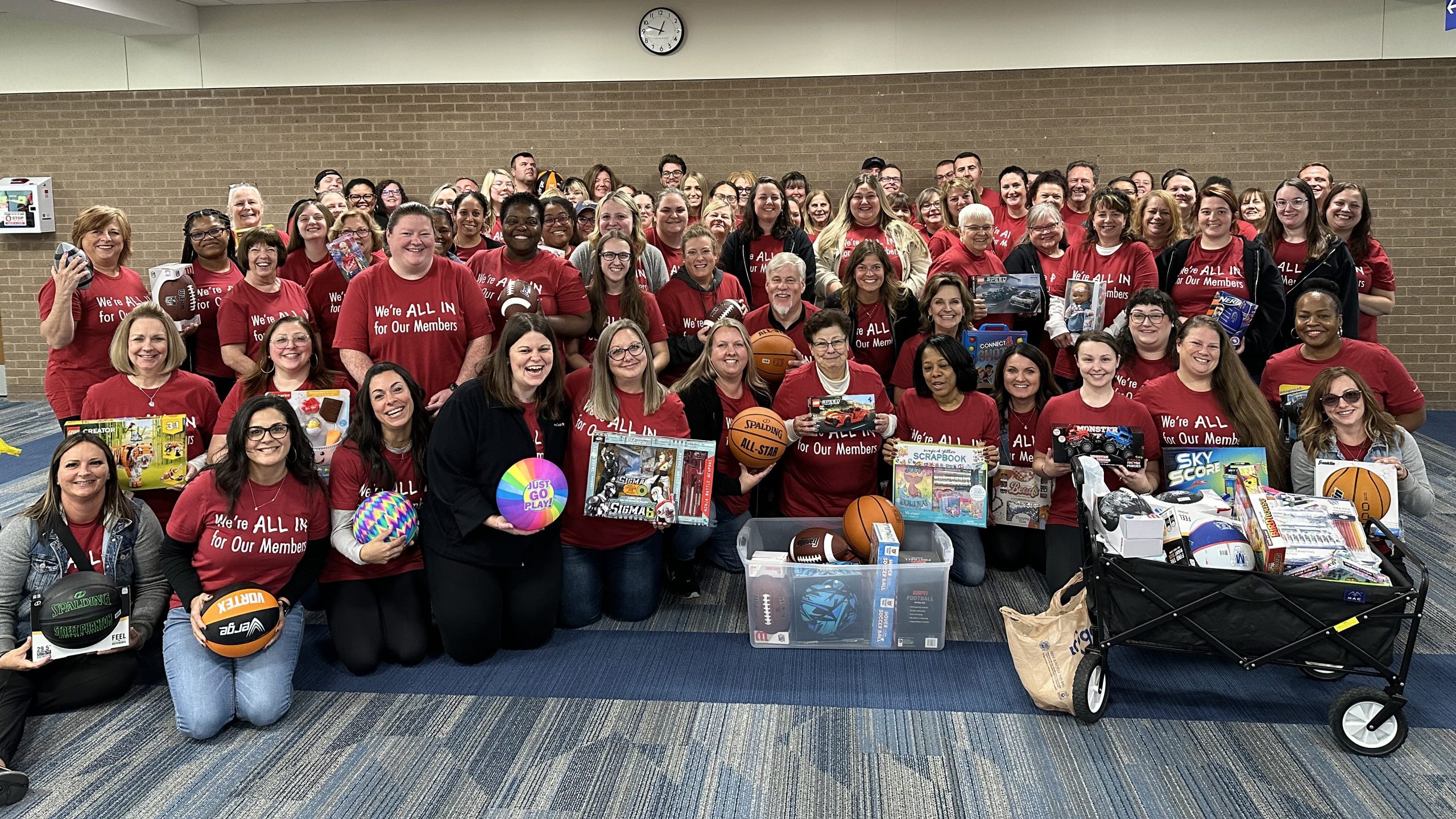 Extra Credit Union employees donating sporting goods to school