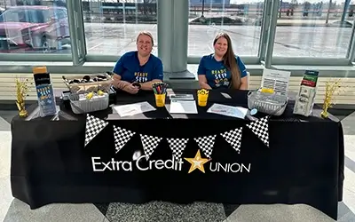 Extra Credit Union employees at a booth