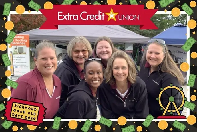 Extra Credit Union employees posing for a photo at a community event