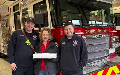 Extra Credit Union delivering baked goods to firefighters