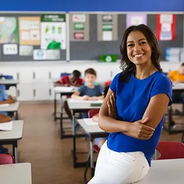 Portrait of African American female teacher smiling in the class at school